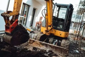 Construction site details with mini excavator digging and working.